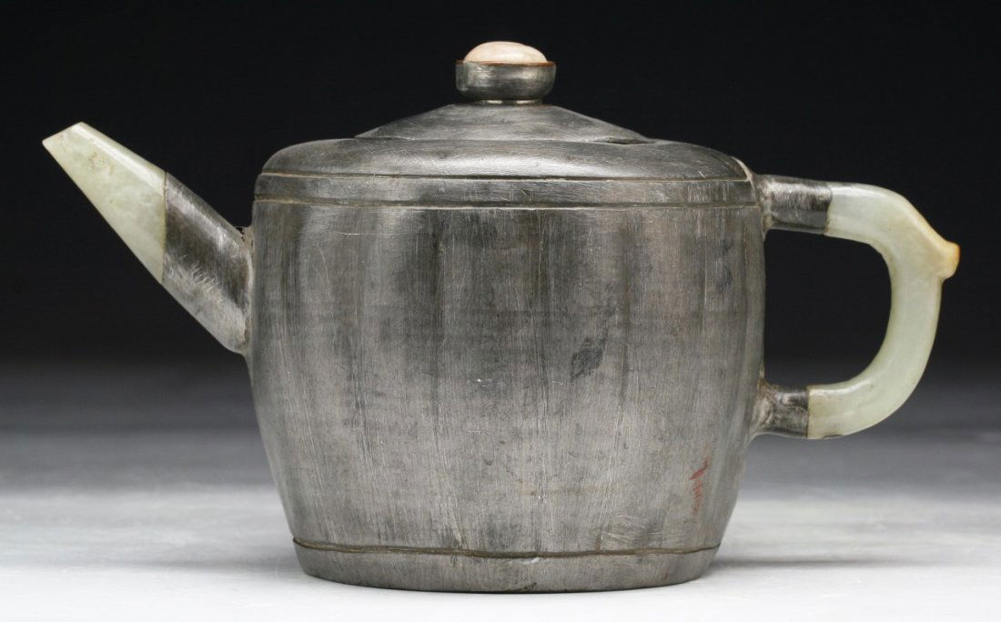A Chinese Antique Jade & Tin Teapot: A Chinese Antique Jade & Tin Teapot: of rounded form with a semi-translucent celadon jade handle and spout, Circa 1900; Size: L: 6-1/2"