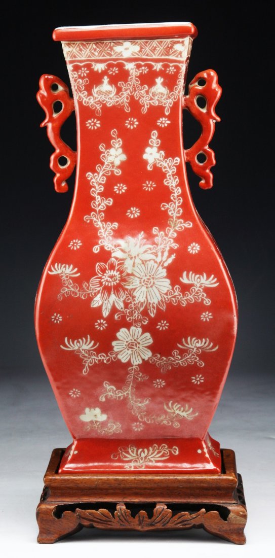 A Fine Chinese Antique Famille Rose Porcelain Vase: A Fine Chinese Antique Famille Rose Porcelain Vase: angled flaring sides with flat backed form, the neck with dragon shaped handles, presented on a wood stand, of Qing Dynasty; Size: H: 12"; (overall)