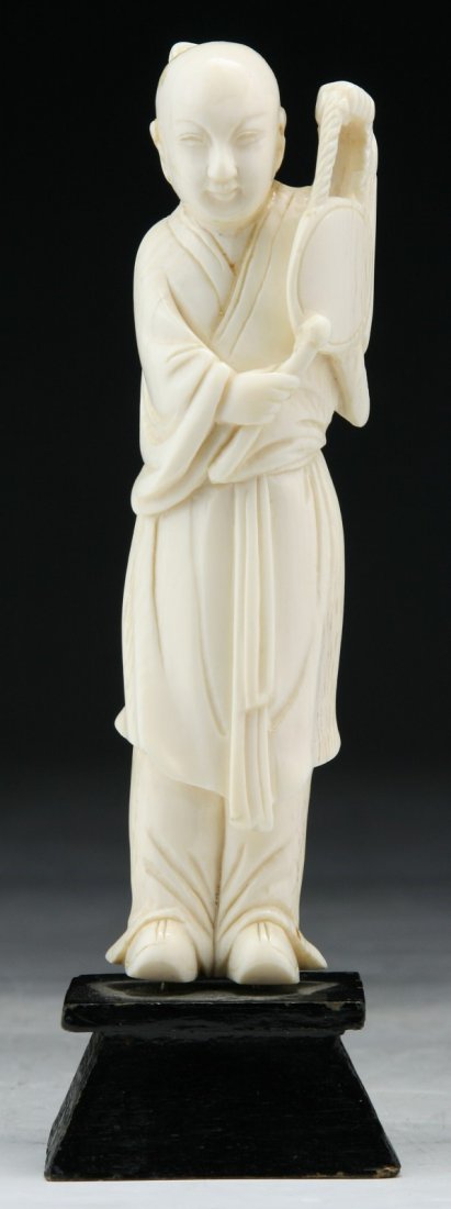 A Chinese Antique Carved Ivory Figure: A Chinese Antique Carved Ivory Figure: carved as a sage standing in layered robes; Size: H: 6" (overall)