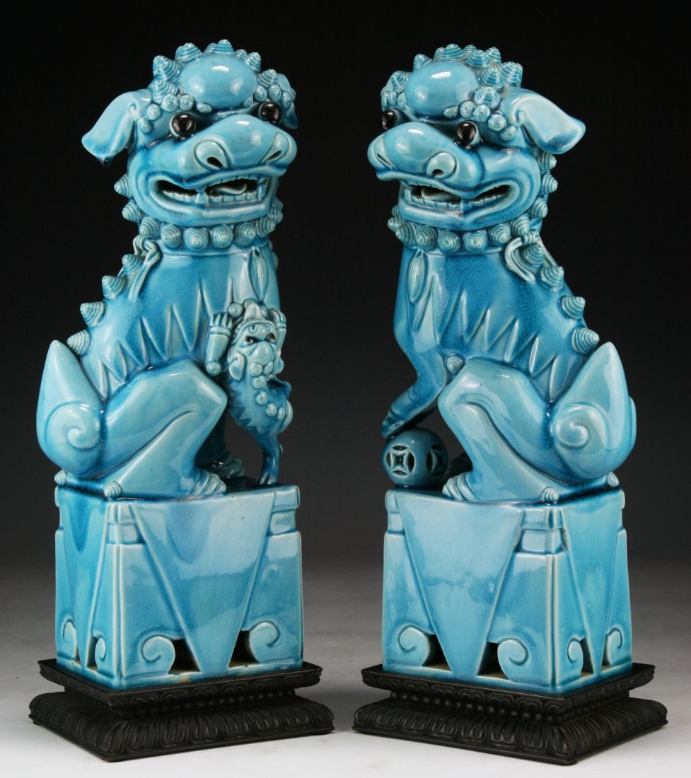 Pair of Chinese Antique Blue Glazed Porcelain Foo Dogs: Pair of Chinese Antique Blue Glazed Porcelain Foo Dogs: presented on a wood stand; Size: H: 14"; (overall) H: 15-1/2"