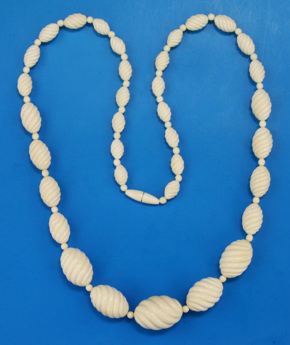 A Chinese Antique Ivory Carved Beaded Necklace: A Chinese Antique Ivory Carved Beaded Necklace: comprised of graduating sizes of ivory beads with the biggest measuring approximately 28mm in length, African ivory, Minguo Period (Early 20th Century),