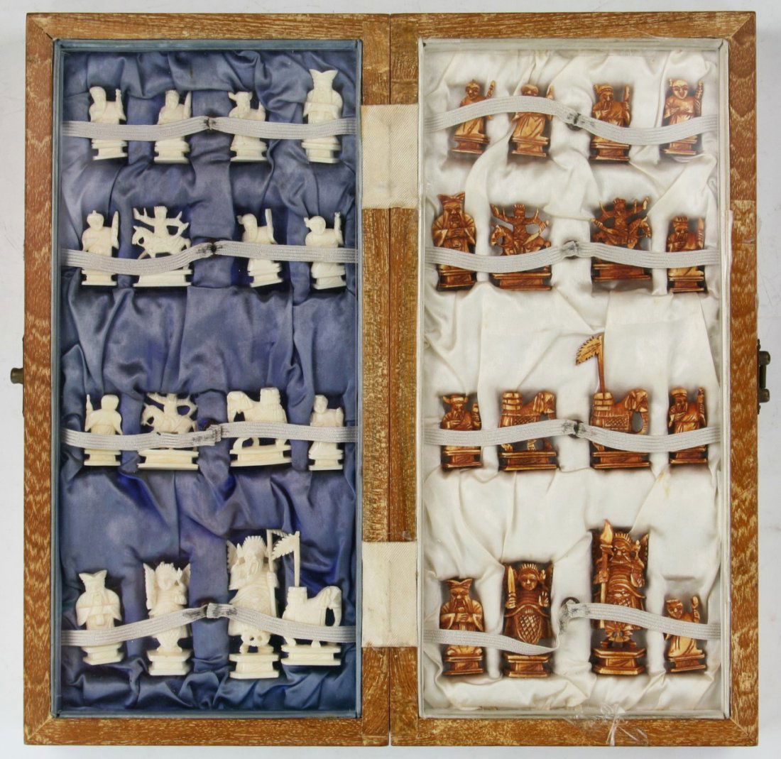 A Complete Set of Chinese Carved Ivory Chess: A Complete Set of Chinese Carved Ivory Chess: all pieces present, the opposing sides of white ivory and sienna dyed ivory are all solid carved pieces all raised on plinths, in wood box, African ivory,
