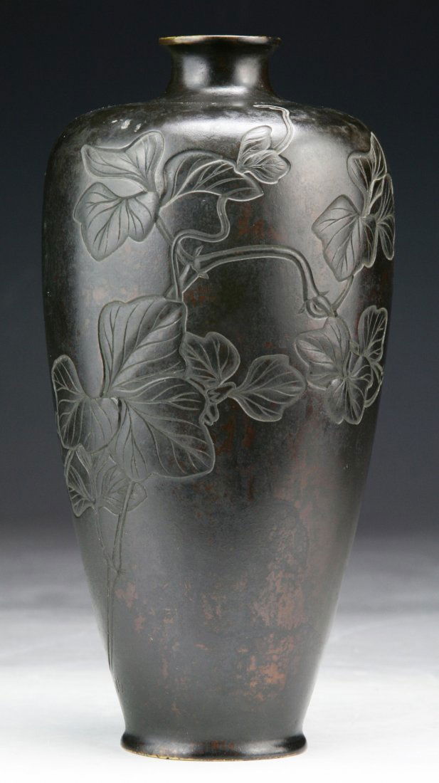 A Japanese Antique Bronze Vase: A Japanese Antique Bronze Vase: of highly shouldered form with a short neck to a slightly flared rim, incised on the body with leafy stems, of 19TH Century; Size: H: 7-3/4"