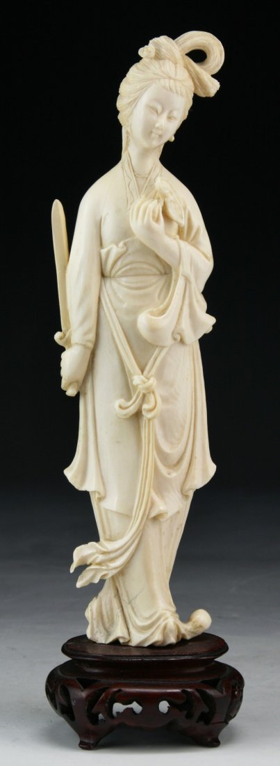 A Chinese Antique Ivory Carved Beauty: A Chinese Antique Ivory Carved Beauty: finely detailed carved as a beauty in a flowing robe; presented on a wood stand, African ivory, Late Qing Dynasty (19th Century), NO INTERNATIONAL SHIPPING OF IV