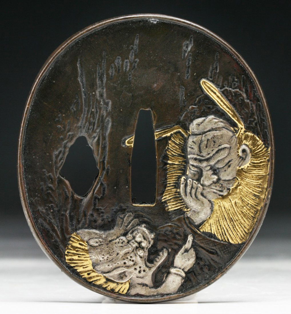 A Japanese Antique Bronze Tsuba: A Japanese Antique Bronze Tsuba: mounted in silver and gold; Size: D: 3"