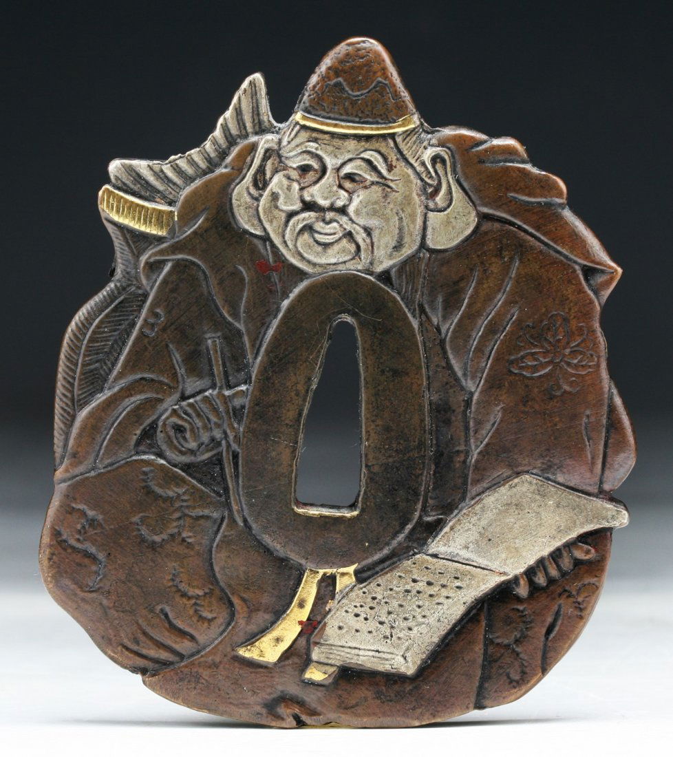 A Japanese Antique Bronze Tsuba: A Japanese Antique Bronze Tsuba: mounted in silver and gold; Size: H: 3"