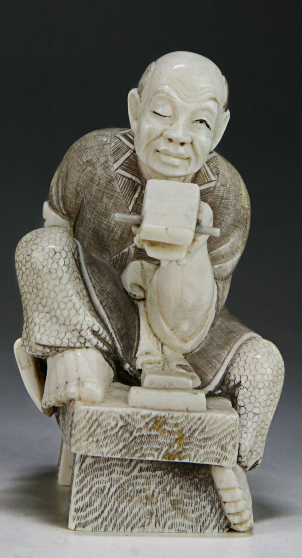 A Japanese Antique Ivory Carved Figure: A Japanese Antique Ivory Carved Figure; finely carved as a man sitting with an ax and piece of wood in his hands, African ivory, of late 19th Century, NO INTERNATIONAL SHIPPING OF IVORY ITEMS; Size: H