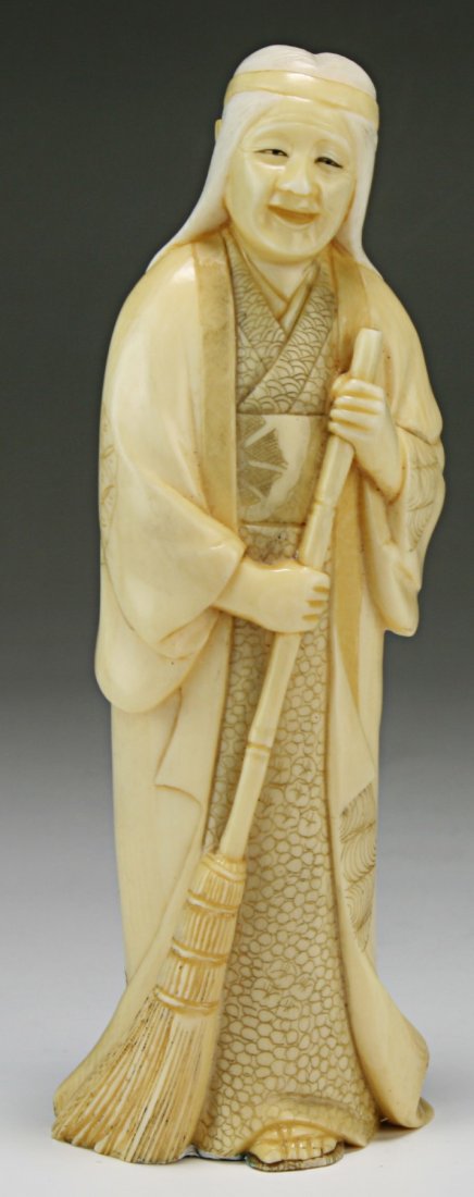 A Japanese Antique Ivory Carved Figure: A Japanese Antique Ivory Carved Figure: finely carved as a woman in long decorative robes holding a broom with both hands, African ivory, early 20th Century, NO INTERNATIONAL SHIPPING OF IVORY ITEMS;