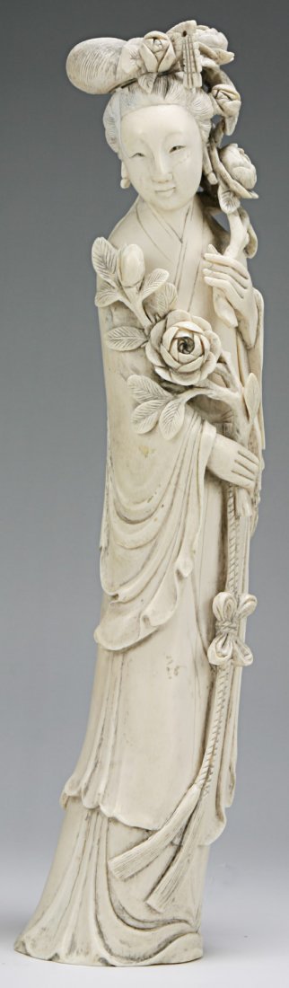 A Chinese Antique Ivory Carved Beauty: A Chinese Antique Ivory Carved Beauty: Finely carved beauty standing in long swaying robes holding blooming branches in both hands, Asian ivory, Middle Qing Dynasty (18th Century), NO INTERNATIONAL SH