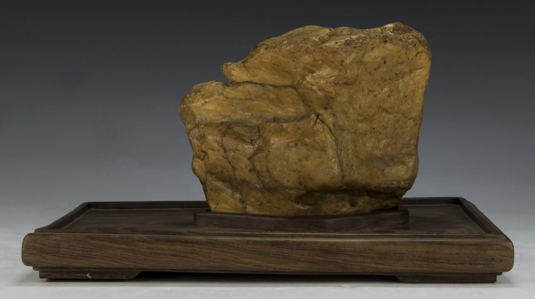 A Soapstone Boulder On Wood Stand: A Soapstone Boulder On Wood Stand; Size: L: 8"; (stand) L: 13-1/4"