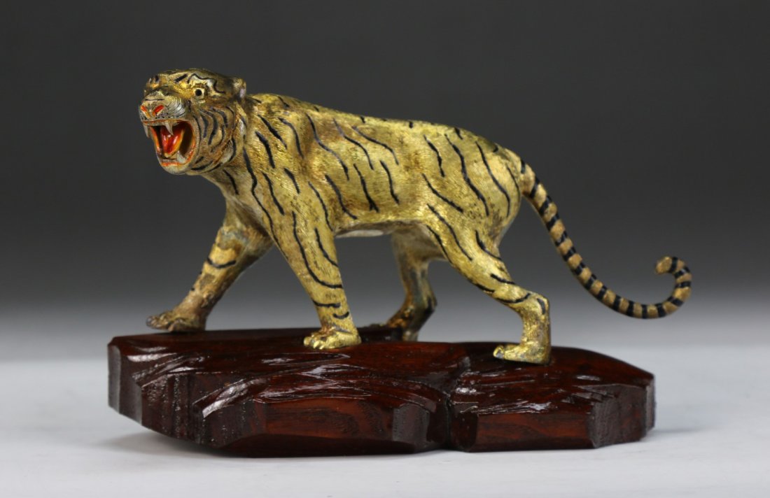 A Chinese Antique Gilt On Silver Tiger: A Chinese Antique Gilt On Silver Tiger: presented on a wood stand; Size: L: 6"