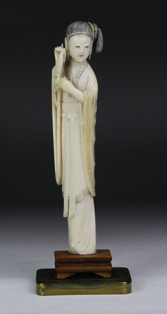 A Chinese Antique Polychrome Ivory Carved Beauty: A Chinese Antique Polychrome Ivory Carved Beauty: finely carved as a beauty in layered robes holding a handkerchief, presented on a wood stand, African ivory, of middle Qing Dynasty (18th Century), NO