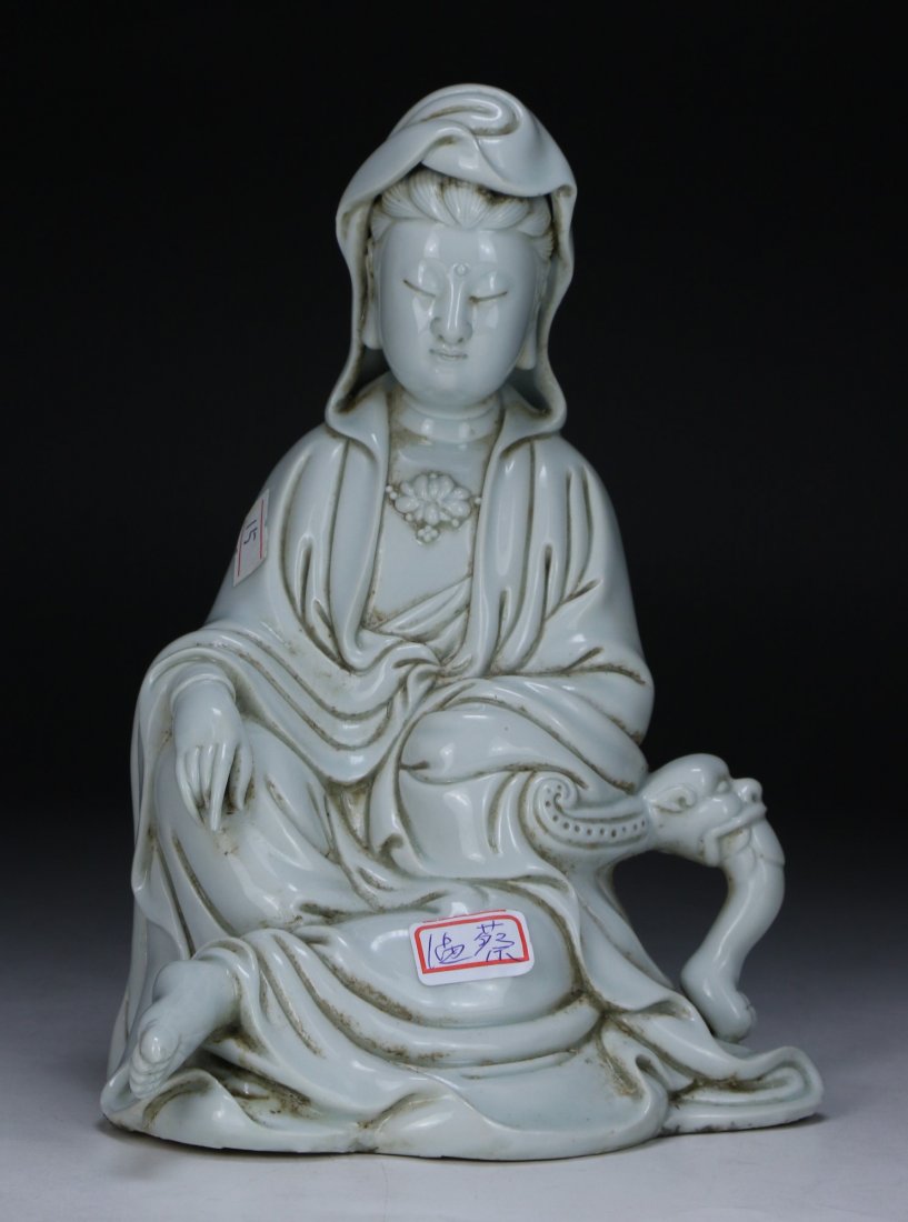 A Chinese White Glazed Porcelain Guanyin: A Chinese White Glazed Porcelain Guanyin: finely detailed as Guanyin in a seated position with draped robes; Size: H: 8-1/2"