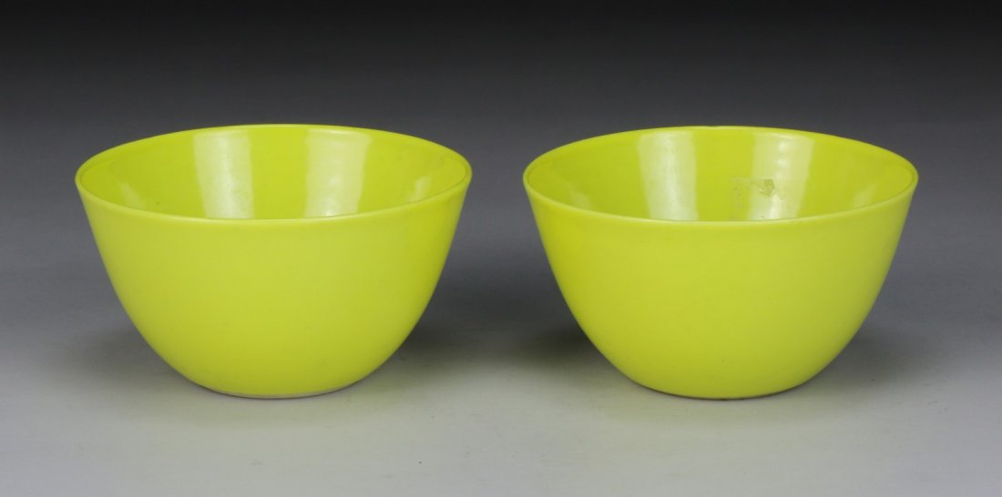 A RARE PAIR OF SMALL LEMON-YELLOW-ENAMELED WINE CUPS: A RARE PAIR OF SMALL LEMON-YELLOW-ENAMELED WINE CUPS: YONGZHENG SIX-CHARACTER MARKS IN UNDERGLAZE-BLUE WITHIN CIRCLES AND OF THE PERIOD (1723-1735), each cup is delicately potted with a deep semi-ovoi