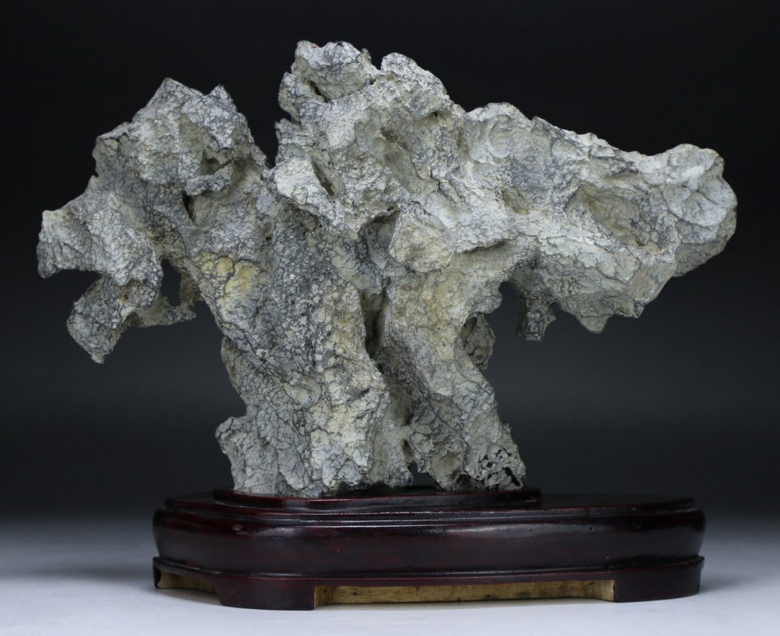 A Chinese Linbi Scholar Rock: A Chinese Linbi Scholar Rock: presented on a wood stand; Size: L: 13"; H: 10"