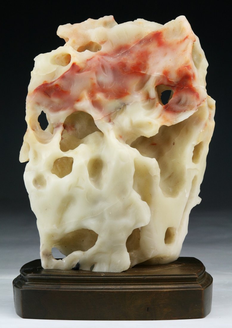 A Chinese Shoushan Soapstone Scholar's Rock: A Chinese Shoushan Soapstone Scholar's Rock: of billowing, cloud-mushroom form, with nodules, crevices and openings throughout, of white coloration with some red areas; Size: H: 8"
