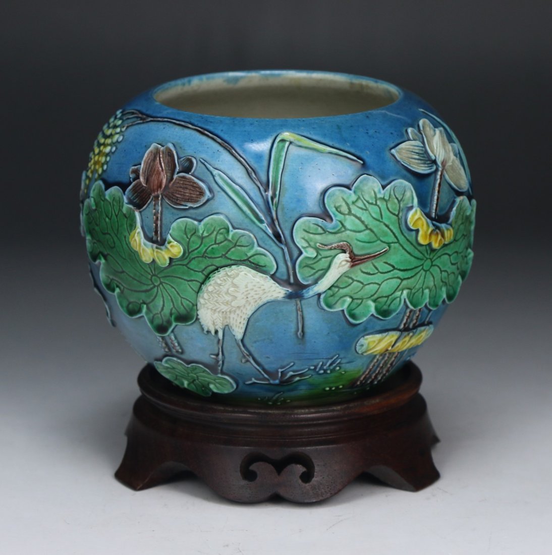 A Chinese Antique Famille Verte Porcelain Bowl: A Chinese Antique Famille Verte Porcelain Bowl: of globular form with a crane standing amid lotus and lily pads, of Minguo Period, presented on a wood stand; Size: D: 5"
