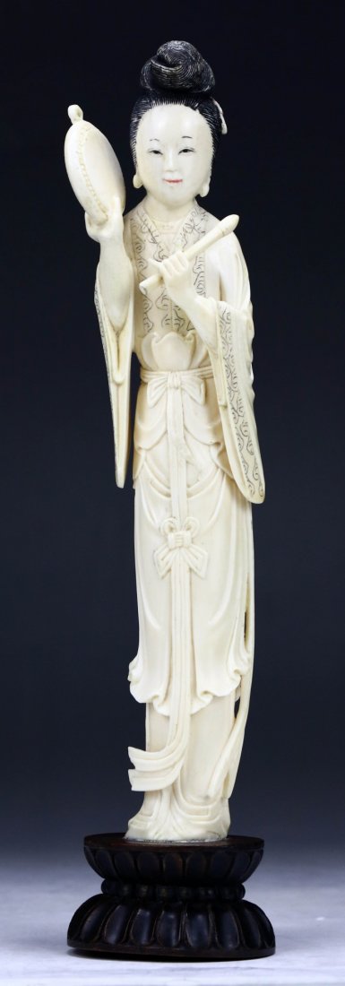 A Chinese Antique Polychrome Ivory Carved Beauty: A Chinese Antique Polychrome Ivory Carved Beauty: finely carved as a beauty in decorative robes holding instruments in both hands, presented on a wood stand, Asian ivory, Middle Qing Dynasty (18th Cen