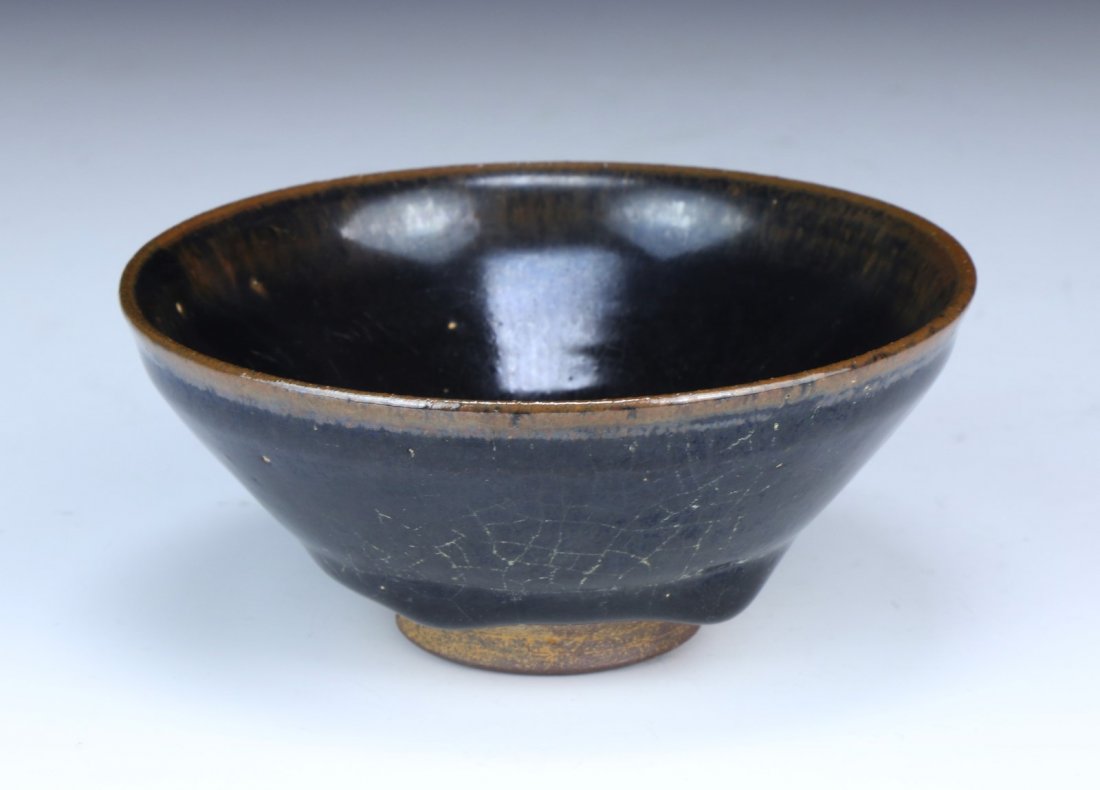 A Chinese Antique JIAN YAO Porcelain Bowl: A Chinese Antique JIAN YAO Porcelain Bowl: the bowl is covered with a thick black glaze finely streaked with iridescent markings, stopping irregularly above the foot exposing the chocolate-brown body,