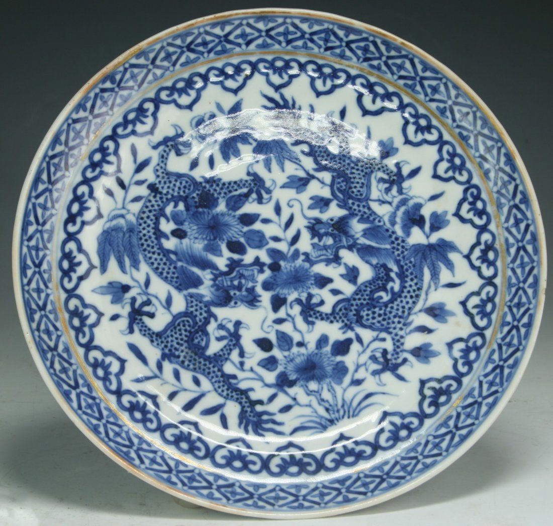 A Chinese Antique Blue & White Porcelain Plate: A Chinese Antique Blue & White Porcelain Plate: vividly painted in underglaze blue to the interior central medallion with two dragons amid lotus scrolls within bands of ruyi heads and lappets, with 'Y