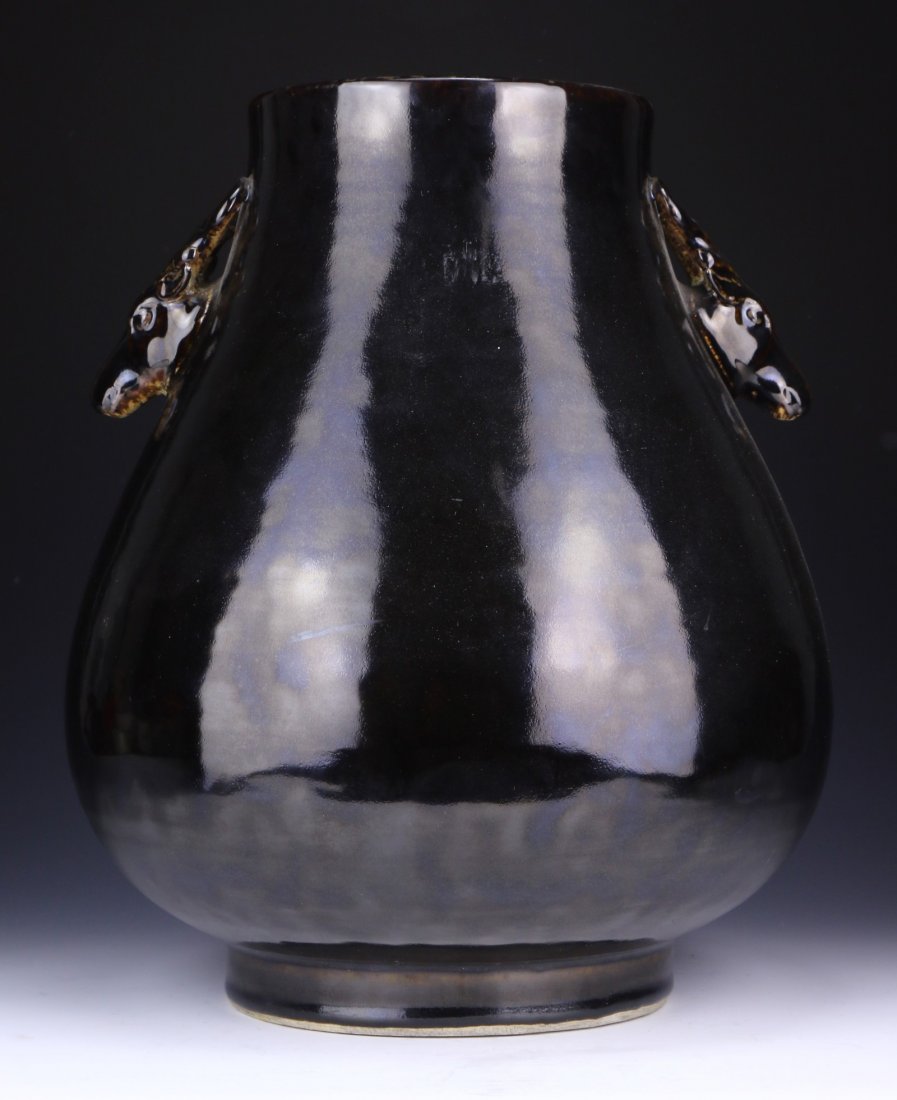 A Big Chinese Antique Aubergine Glazed Porcelain Zun: A Big Chinese Antique Aubergine Glazed Porcelain Zun: of bulbous form rising to a wide mouth, with two twin deer head shaped handles resting on the neck, with an all over black glaze, of Qing Dynasty;