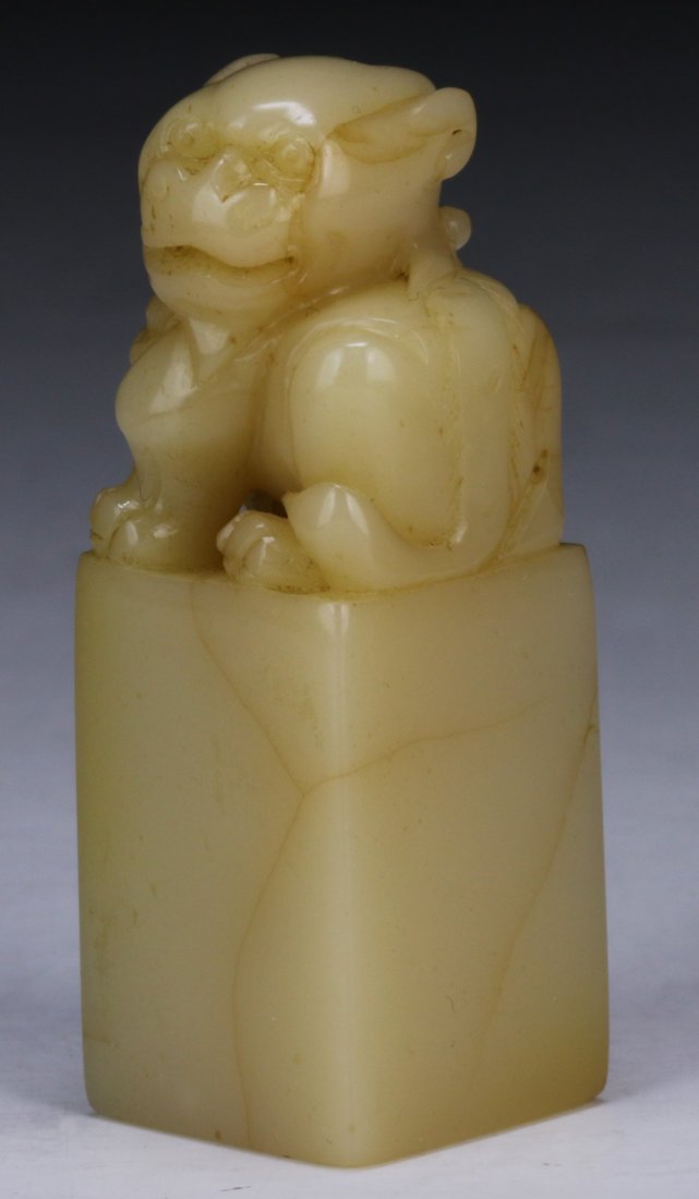 A Chinese Soapstone Carved Seal: A Chinese Soapstone Carved Seal: finely carved with a Qilin sitting atop a square pedestal; Size: H: 2"