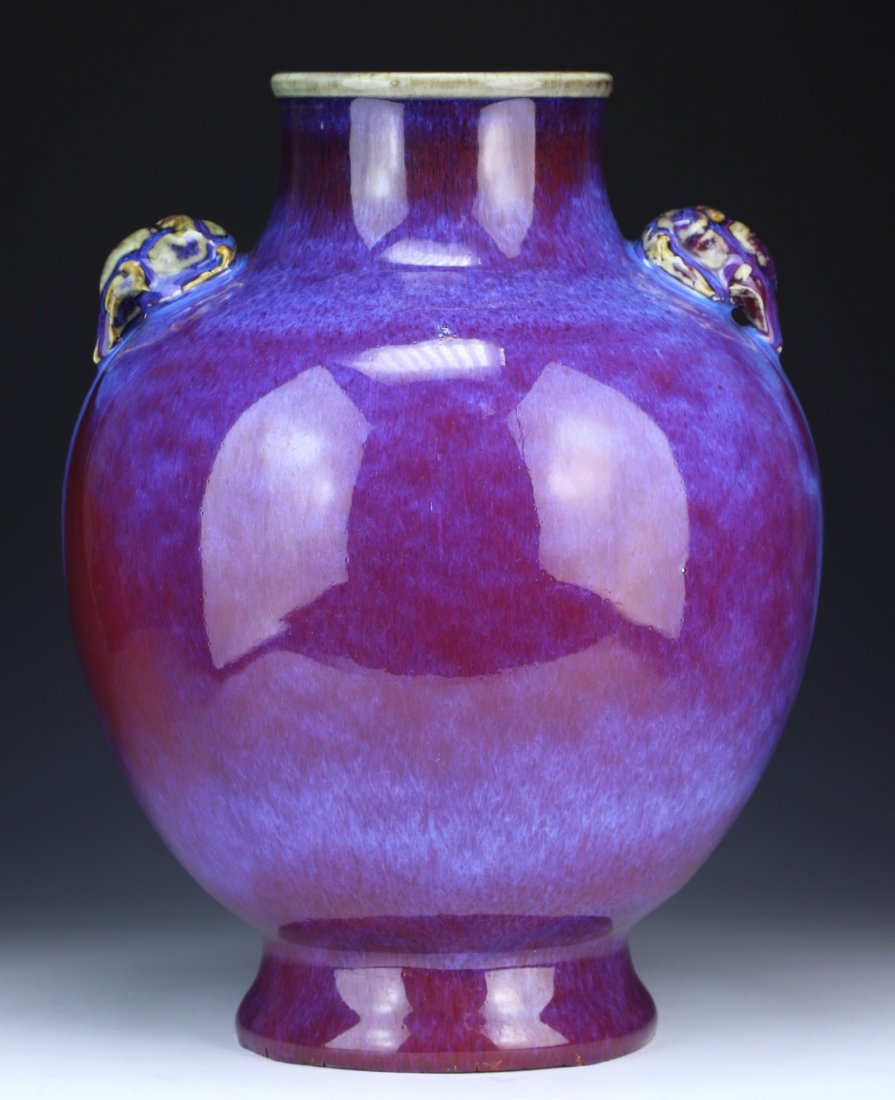 A Chinese Antique Rouge Glazed Porcelain Vase: A Chinese Antique Rouge Glazed Porcelain Vase: of globular form rising to a short neck, with elephant head handles on each side, glazed overall with bluish purple tone while base left unglazed, of Qin
