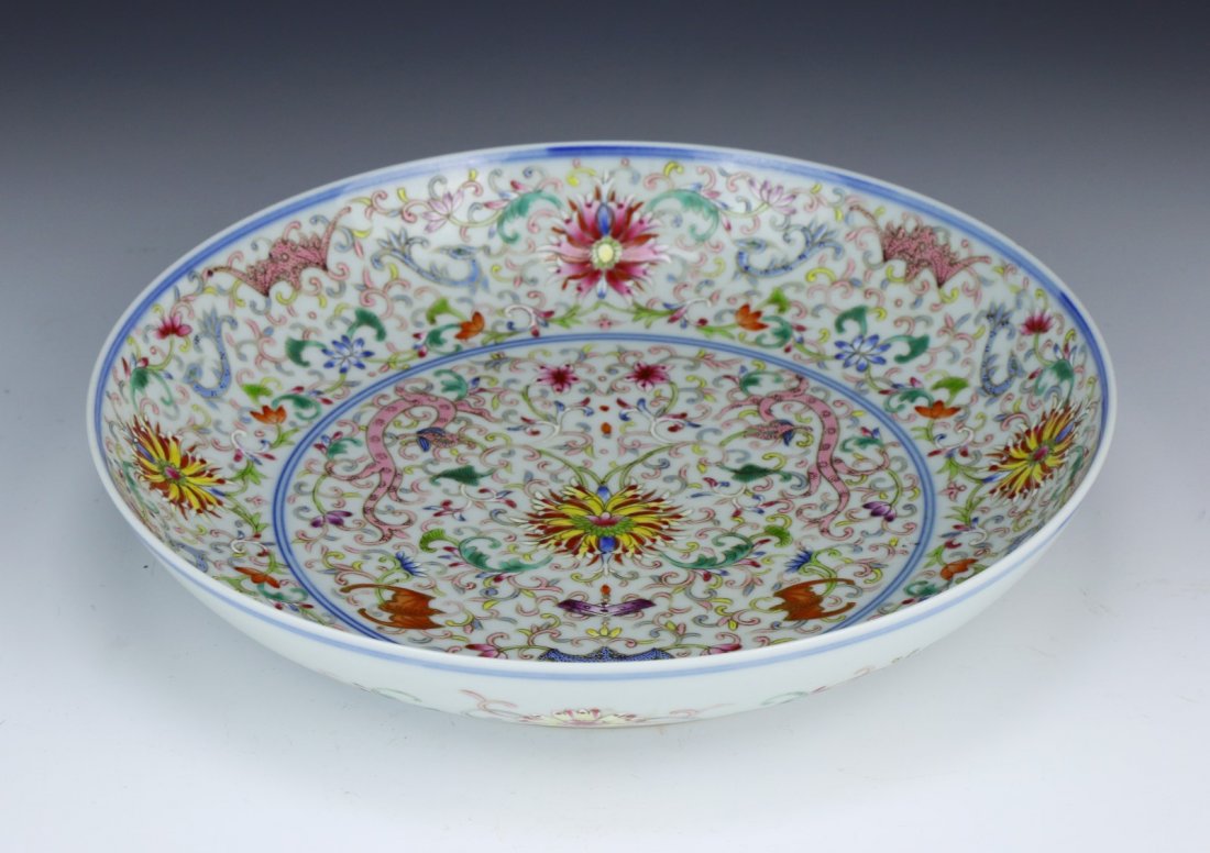 A Chinese Antique Famille Rose Porcelain Plate: A Chinese Antique Famille Rose Porcelain Plate: the interior finely painted with a floral motif, with a YONGZHENG mark within a double circle in blue on the base; Size: D: 8-1/4"