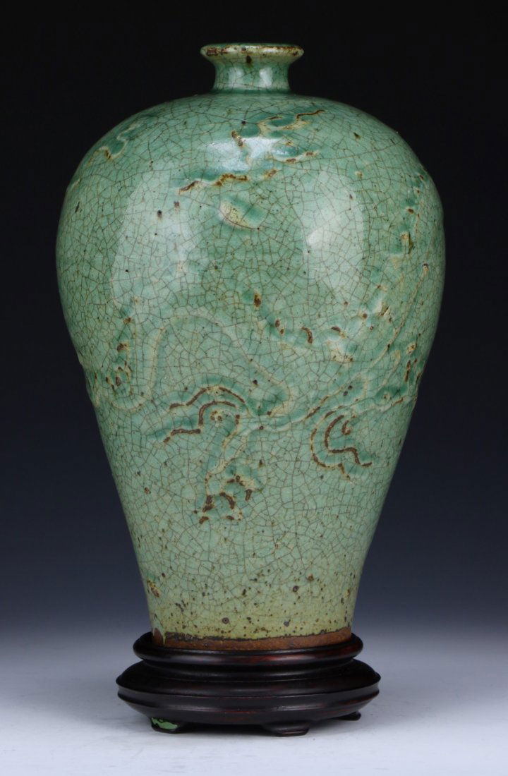 A Chinese Antique Celadon Glazed Porcelain Vase: A Chinese Antique Celadon Glazed Porcelain Vase: of high rounded shoulder form, with a crackle celadon glaze, MING DYNASTY, presented on a wood stand; Size: H: 9-1/2"; (overall) H: 10-1/2"