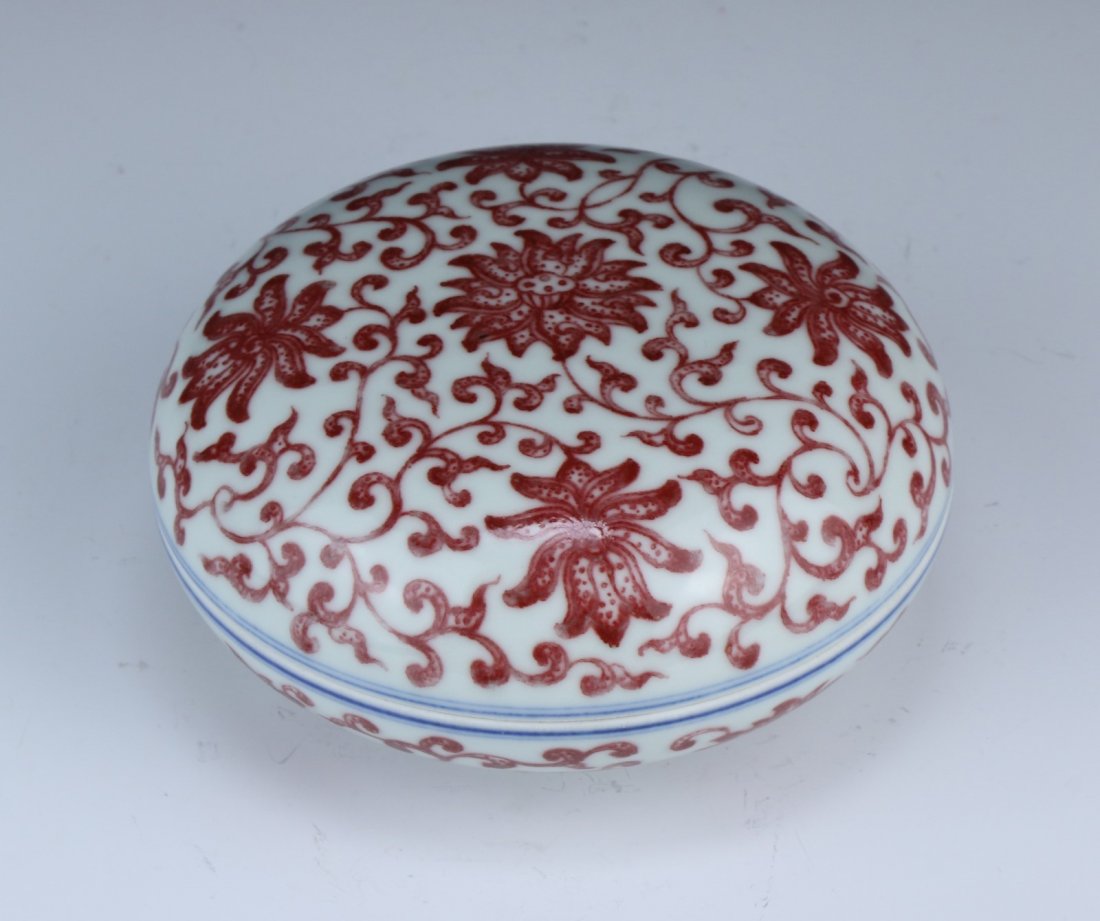 A Chinese Antique Blue & White Underglazed Red: A Chinese Antique Blue & White Underglazed Red Porcelain Ink Case: of flattened globular form, with the all over design of blossoms with scrolling vines, sign QIANLONG on the base; Size: D: 5"