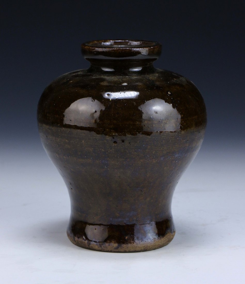 A Chinese Antique Flambe Porcelain Vase: A Chinese Antique Flambe Porcelain Vase: of bulbous form, with an all over brown glaze; Size: H: 5"