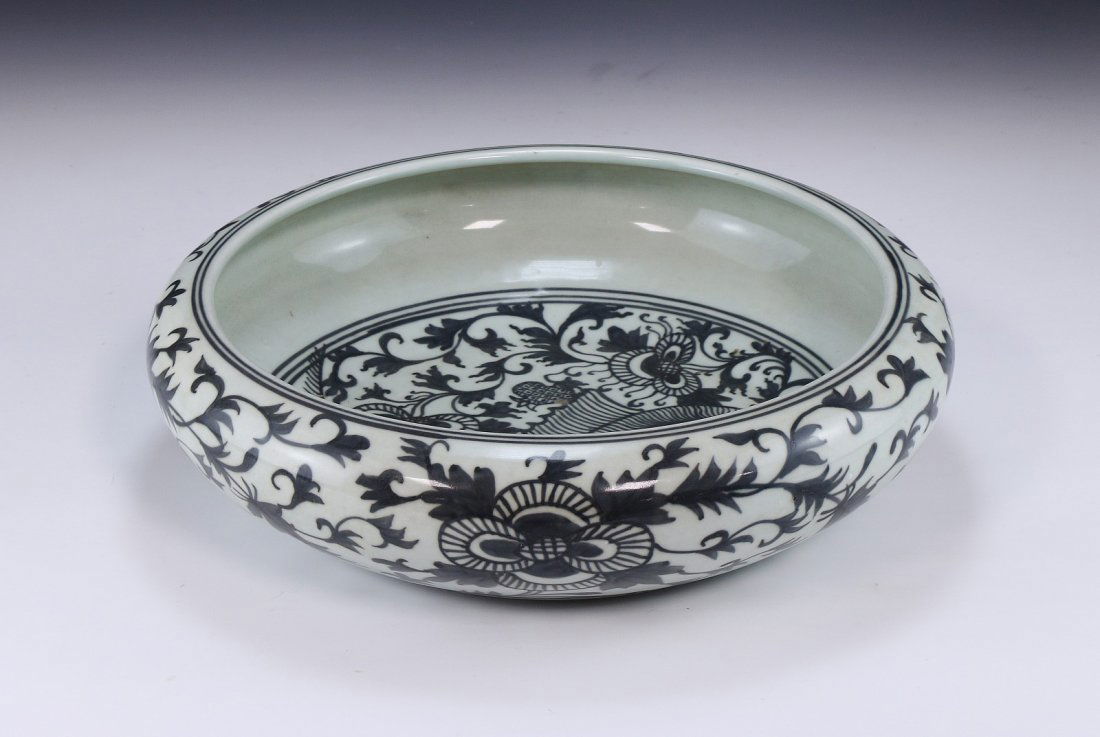 A Chinese Antique Blue & White Porcelain Brush Washer: A Chinese Antique Blue & White Porcelain Brush Washer: HONGWU SIX-CHARACTER SEAL MARK IN DEEP UNDERGLAZE BLUE, The vessel is skilfully potted with a compressed body supported on a short tapered foot,