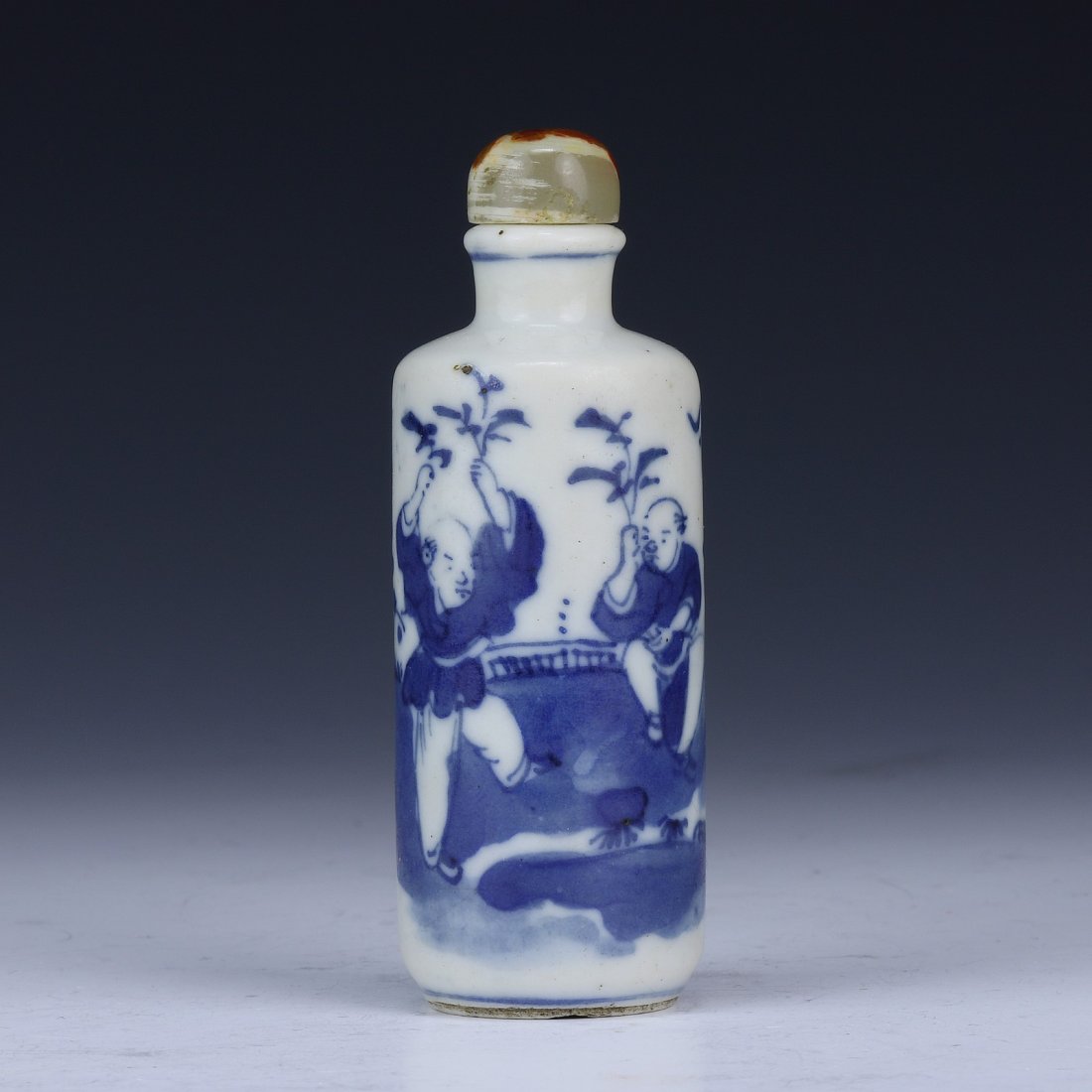 A Chinese Antique Blue & White Porcelain Snuff Bottle: A Chinese Antique Blue & White Porcelain Snuff Bottle: painted around the cylindrical body with the scene of kids playing in a courtyard, of Qing Dynasty; Size: H: 3"