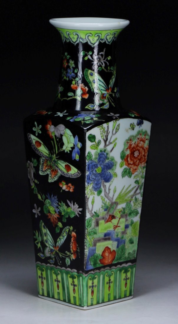 A Chinese Antique Famille Rose Porcelain Vase: A Chinese Antique Famille Rose Porcelain Vase: of square form rising to a flared mouth, the exterior finely painted with butterflies and flowers on a black glazed ground; Size: H: 12"