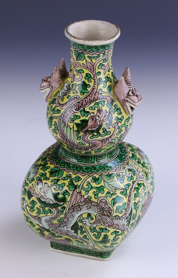A Chinese Antique Famille Verte Porcelain Vase: of gourd form, the exterior finely painted with dragons flying amid leafy vines, the neck with dragon head handles; Size: H: 8-3/4" (22. 225cm)