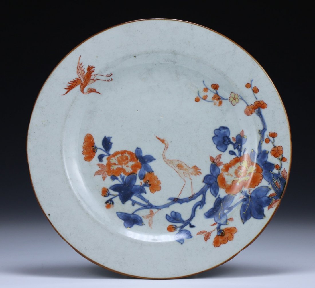 A Chinese Antique Famille Rose Porcelain Plate: the interior finely painted with cranes amid blooming branches, of Mid-Qing Dynasty; Size: D: 9" (22. 86cm)