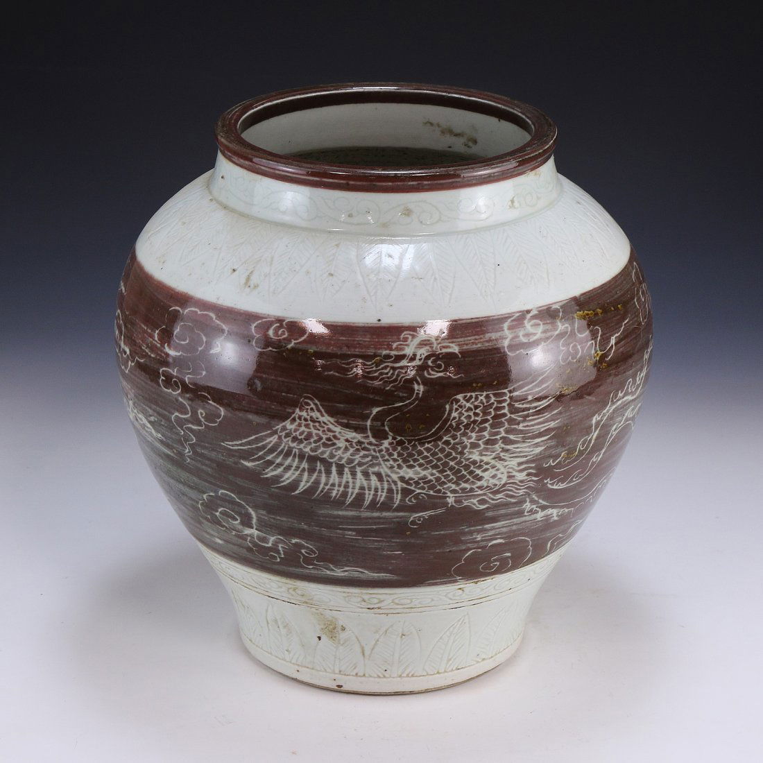 A Chinese Antique Porcelain Vase: of globular form, finely decorated with a bird in flight amongst clouds, stretching upwards towards a large and cylindrical rim; Size: H: 11", D: 10-1/2" (28cm x 27cm)
