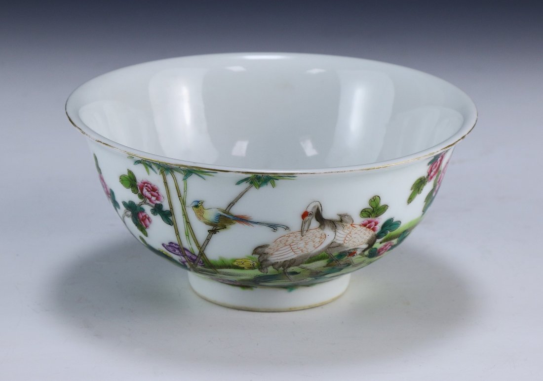 A Chinese Antique Famille Rose Bowl: detailed with various birds resting in a field of grass, plant stalks, and blooming flowers, signed in a six-character QIANLONG in cobalt blue; Size: D: 6-1/4" (16cm)