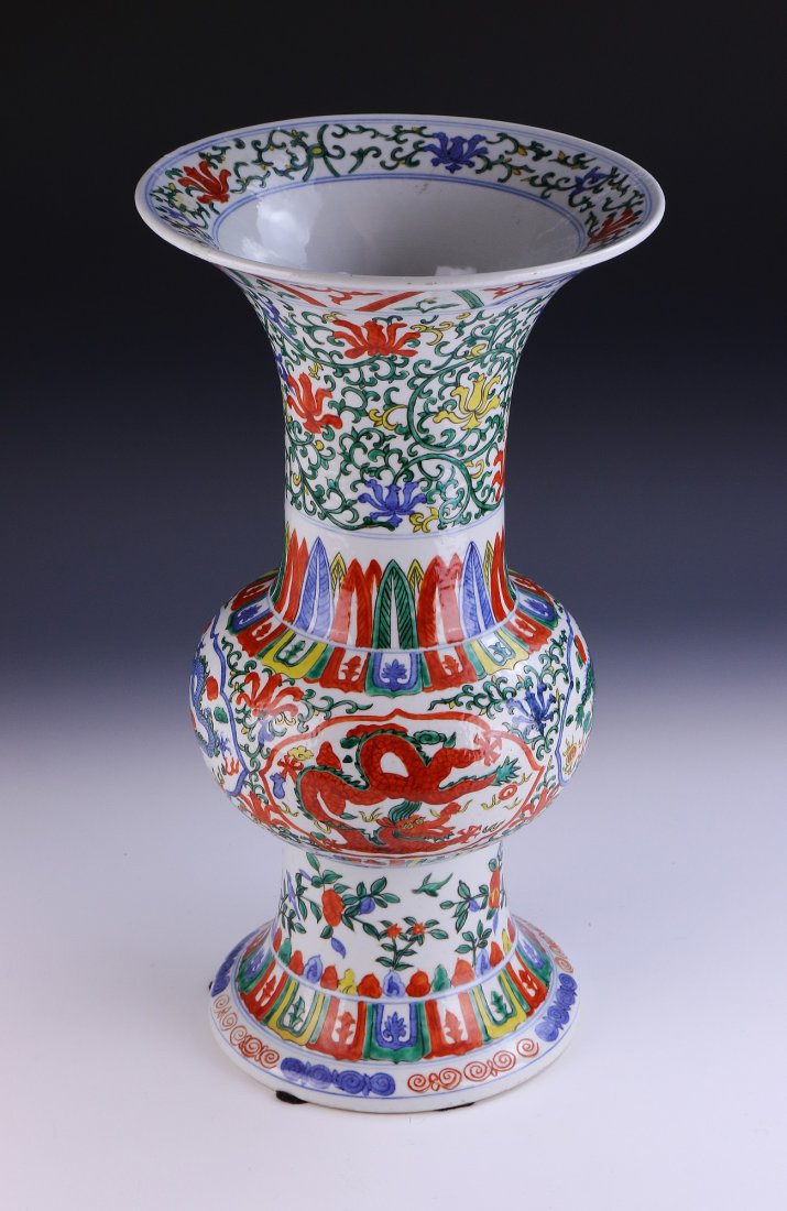 A Chinese Antique Famille Verte Porcelain Vase: of baluster form, with sprawling dragons across the body, and blooming plants across the neck and flared rim of the vase, with a six-character WANLI mark in cobalt blue within a double circle; Size: H