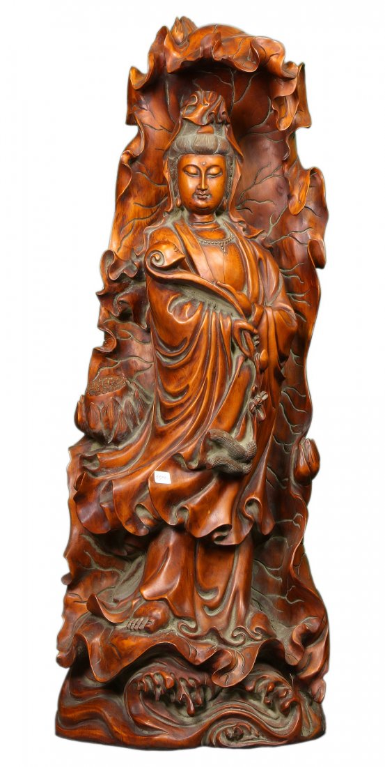 A Massive Chinese Antique Boxwood Carved Guanyin: A Massive Chinese Antique Boxwood Carved Guanyin: finely carved as Guanyin standing in layered and flowing robes within a lotus shaped grotto holding a ruyi; Size: H: 37-1/2"