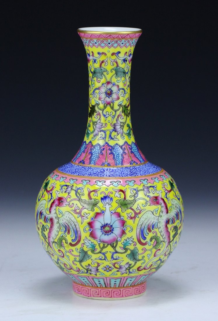 A Chinese Antique Famille Rose Porcelain Vase: A Chinese Antique Famille Rose Porcelain Vase: of globular form rising to a cylindrical neck and slightly flared rim, the body finely painted with phoenix, blooming flowers, and scrolling vines on a y