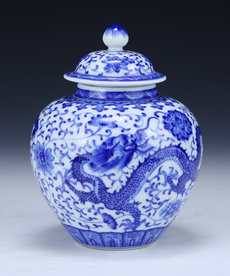 A Chinese Antique Blue & White Porcelain Jar With Cover: A Chinese Antique Blue & White Porcelain Jar With Cover: of globular form with a dome shaped lid, the body finely painted with dragons flying amid blossoms and scrolling vines, with a ‘Qianlong’ m