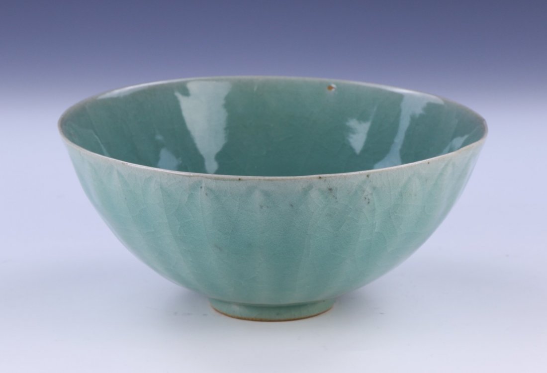 A Chinese Antique Celadon Glazed Porcelain Bowl: A Chinese Antique Celadon Glazed Porcelain Bowl: Evenly Glazed Throughout, With A Crackle Design And A Ridged Finish; Size: D: 8" (20.32cm)