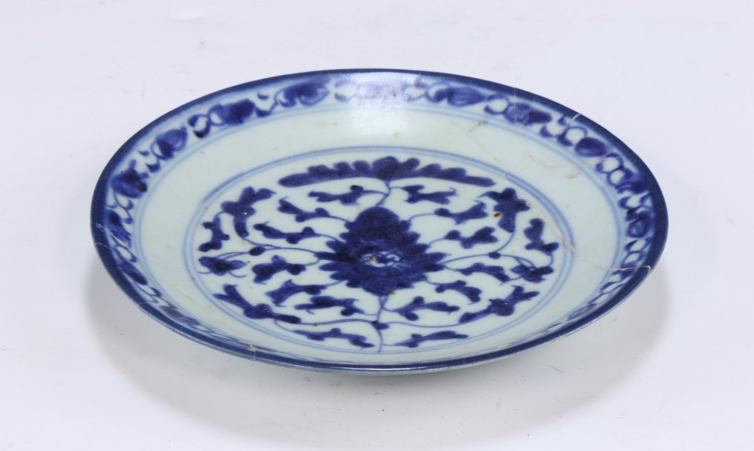 A Chinese Antique Blue & White Porcelain Plate: A Chinese Antique Blue & White Porcelain Plate: The interior And Back Rim Finely Painted With A Blossom And Leafy Scrolling Vines, The Base With A Sign in Cobalt Blue; Size: D: 7" (17.78cm)
