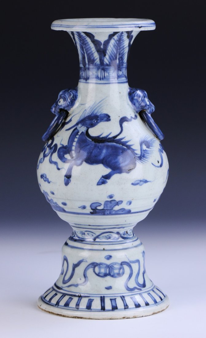 A Chinese Antique Blue & White Porcelain Vase: A Chinese Antique Blue & White Porcelain Vase: Of Baluster Form Rising To A Flared Rim, Finely Painted Around The Body With Dragons Flying Amid Clouds, With Blue Glazed Masks Handles Holding Rings Mol