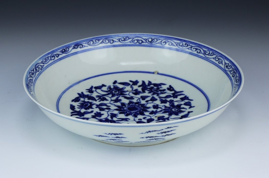 A Chinese Antique Blue & White Porcelain Plate: A Chinese Antique Blue & White Porcelain Plate: The interior Finely Painted With A Scrolling Floral And Leaf Motif At The Center, With A Qianlong Mark On The Base; Size: D: 8-1/2"