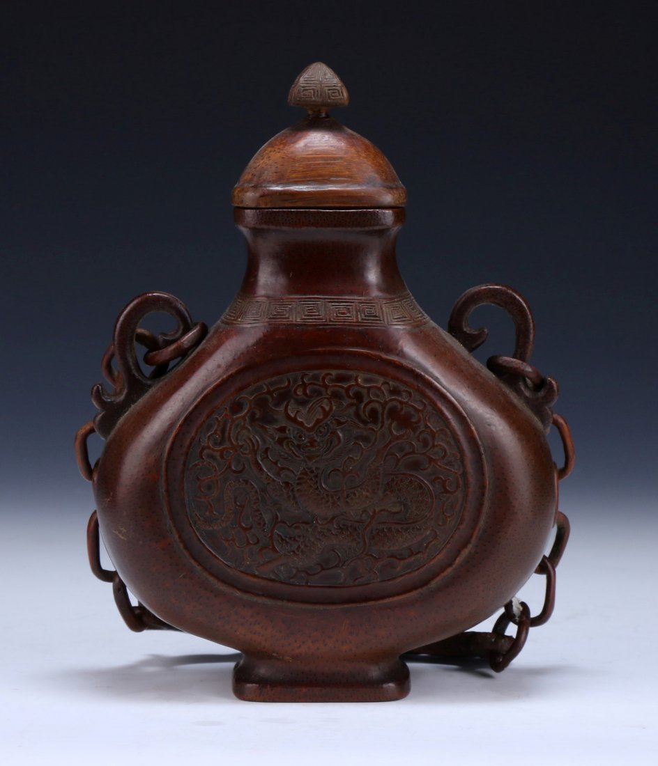 A Chinese Antique Carved Bamboo Hanging Vase: 竹根雕龍紋掛瓶A Chinese Antique Carved Bamboo Hanging Vase: Qing Dynasty, Late 19Th Century, The Hollowed Vessel Is Carved Of Flat Compressed Globular Form, W