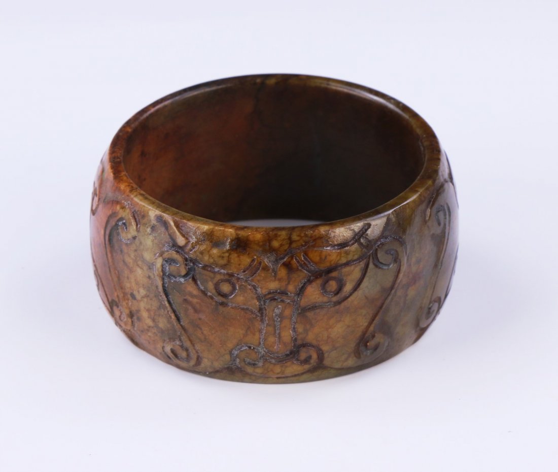 An Archaic Jade Carved Bangle (1 of 2)