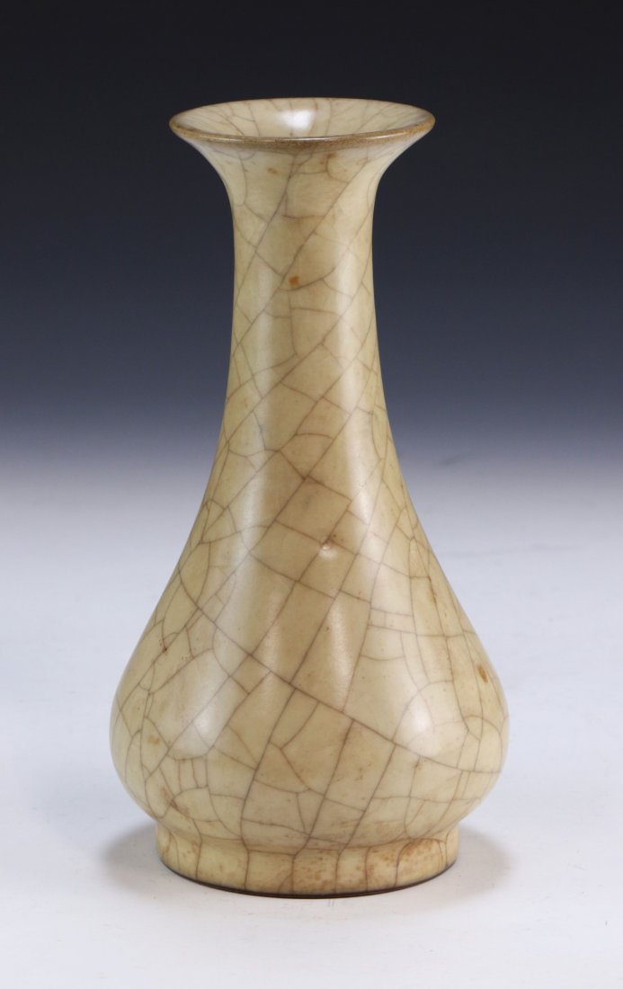 A CHINESE ANTIQUE CELADON GLAZED PORCELAIN VASE: A Chinese Antique Celadon Glazed Porcelain Vase: Body Of Pear Form, Rising To A Cylindrical Neck And Outwardly Flared Rim, Finely Glazed With A Crackle Finish Throughout; Size: H: 8" (20.32cm)
