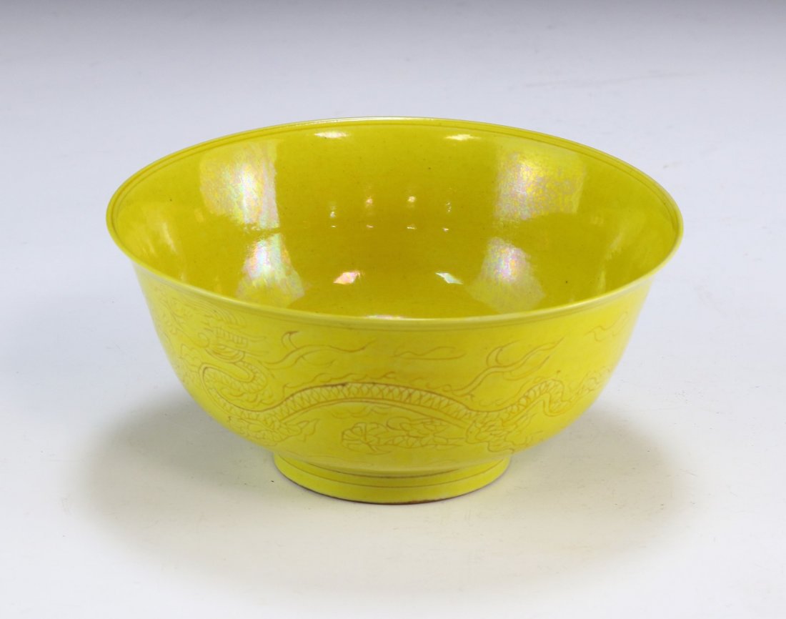 A CHINESE ANTIQUE YELLOW GLAZED PORCELAIN BOWL: A Chinese Antique Yellow Glazed Porcelain Bowl: Of Rising Sides, Exterior Finely Painted With Two Swirling Dragons Chasing A Flaming Pearl Amid Scrolling Clouds, With The interior Base Painted With An